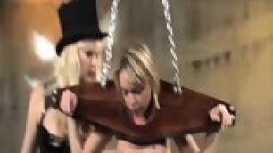 Blonde Shackled In Wooden Restraints Punished In Femdom
